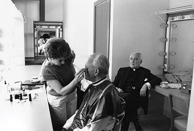 Father Ted watches as Father Ned Joyce, CSC, is prepped for a retirement ceremony in 1987.