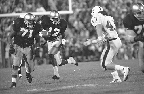 Dean Brown clears a path for Ricky Watters, South Bend Tribune