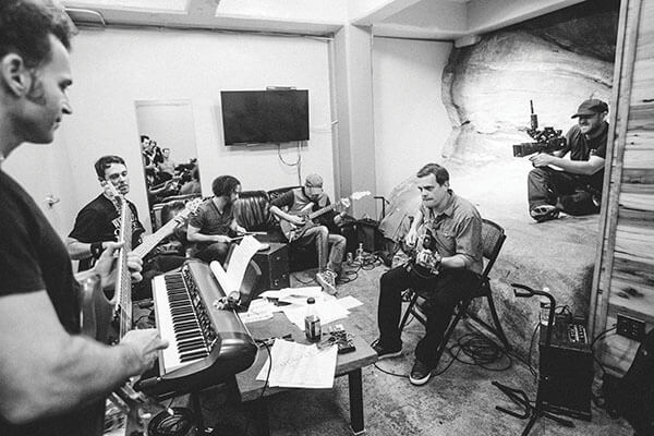 Dweezil Zappa (left), who opened for Umphrey’s McGee at Red Rocks, joins the band in the amphitheatre’s rehearsal room carved into the mountain, photo by Abby Fox