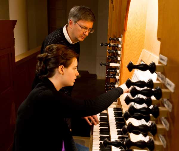 Graduate student Leora Nauta practices with professor Craig Cramer in the Reyes Organ and Choral Hall.