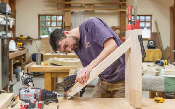 Andreas Schonger shapes one of the rising, curved toeboards that will showcase the Murdy’s façade pipes.