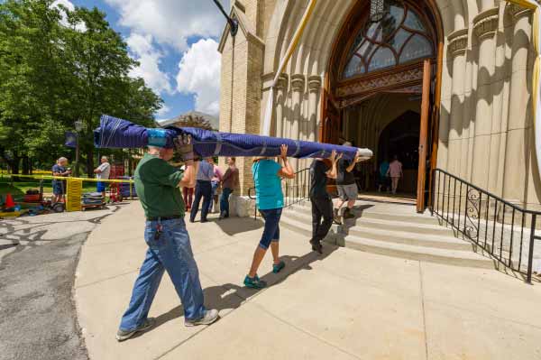 Members of Paul Fritts' crew and Notre Dame volunteers carry parts for the Murdy Family Organ into the Basilica of the Sacred Heart.