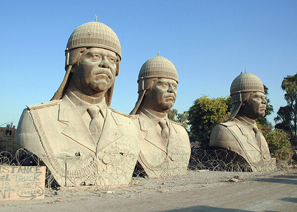Thirty foot tall sculptures of deposed Iraq president Saddam Hussein sit on the grounds of the former Republican Palace in central Baghdad, 2005.