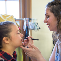 Lizzie Graff is a 12-year-old girl, but she plays the warrior/kidnapper Belarius who lives in a cave with his stolen boys. Director Christy Burgess applies a makeup mustache to help with the transformation.
