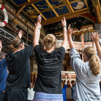 Robinson Shakespeare Company members follow the direction of The Globe Theatre's Master of Movement during a workshop on the stage of the iconic playhouse in London.