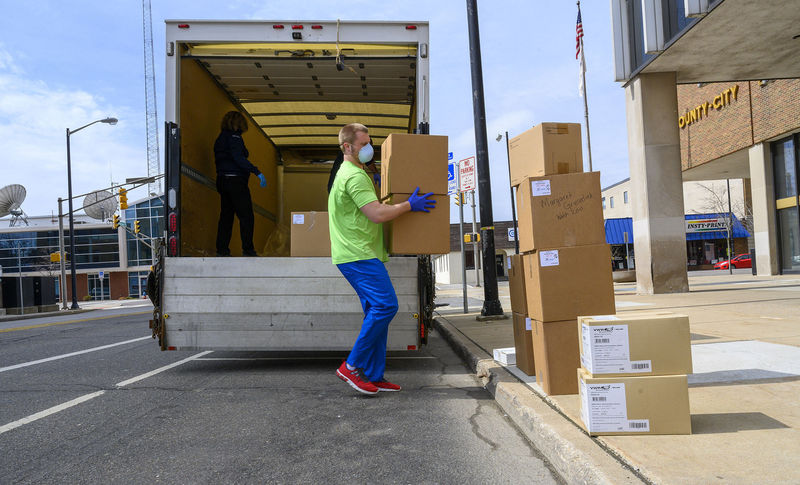 Worker unloads boxes of donated protective gear