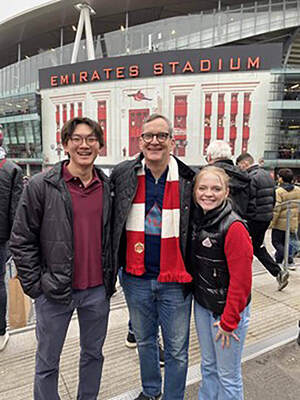 Three people -- Young Mu Lee, Thomas McCabe and Jillian Casey pose outside Emirates Stadium.
