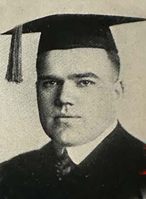 A yearbook photo of Second Lieutenant Arnold McInerny wearing a cap and gown.