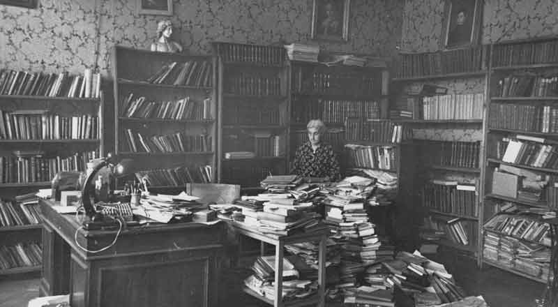 Rusudana, ca. 1970, in the family apartment in Tbilisi, surrounded by her library and archive.