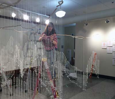 Sandra Fernádez installing ofrenda at the Notre Dame Center for Arts and Culture