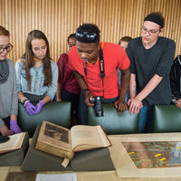 Robinson Shakespeare Company members tour archival materials from the Shakespeare Birthplace Trust.