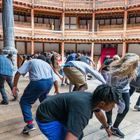 Robinson Shakespeare Company members twirl on stage at Shakespeare's Globe in London during a workshop with the theater's Master of Movement, Glynn MacDonald.