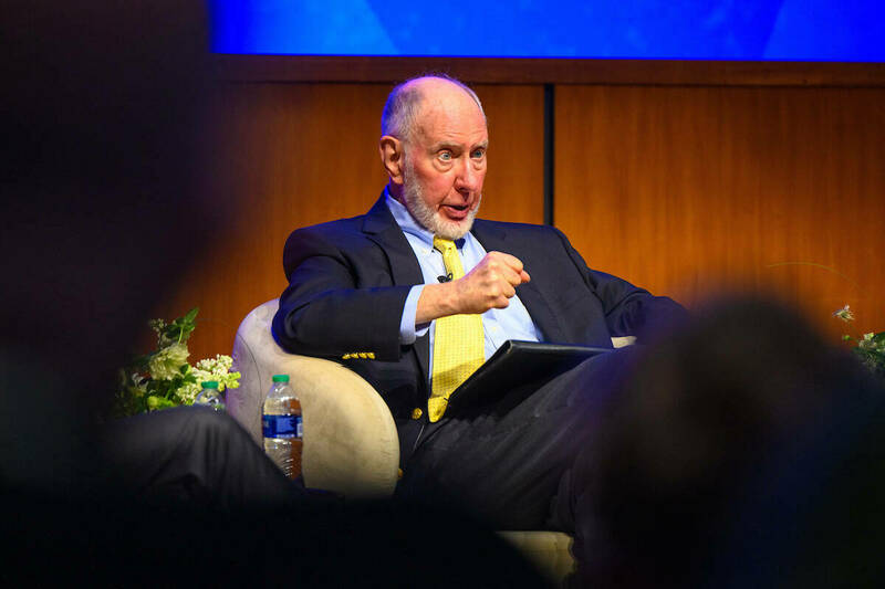 Seated on stage, Robert Putnam speaks to an audience at Notre Dame about the need for creating more and stronger social connections.