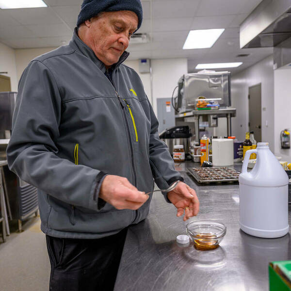 Alan Seidler, chef manager of Corby Hall, tests the maple syrup he makes from campus trees.