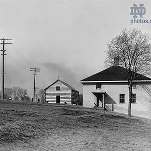 An early photograph showing the Founders Monument, Log Chapel and Old College building at the University of Notre Dame.