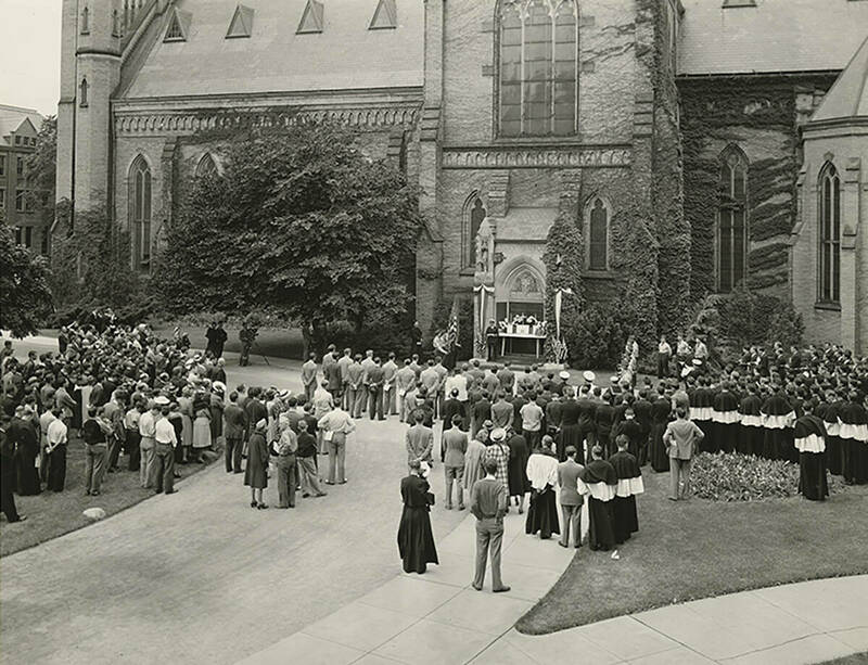 A group of people gathered outside Sacred Heart Church in May 1941 for a field Mass