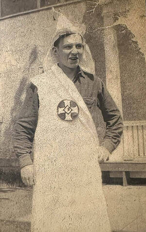 Notre Dame student William Foohey, wearing a Klan robe and hood (pushed to the top of his head so his face is visible). Foohey reportedly stole the robe from a visiting Klansman in May 1924.