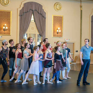 A group of dancers lean forward during a rehearsal for the Raffaella ballet.