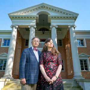 Duncan and Ruth Stroik pose for a photo in front of their four-columned home.