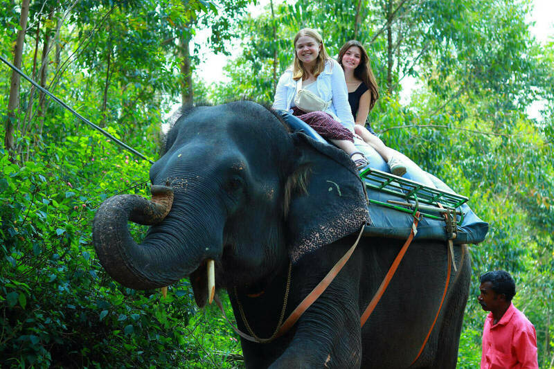 Notre Dame students Genevieve Cicchiello and Eva Tedrick ride an elephant