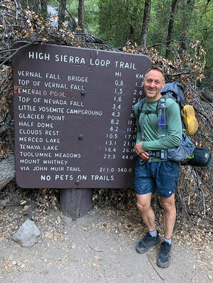 Chris Chaippinelli poses by a sign for the High Sierra Loop Trail, part of his hike on the John Muir Trail.