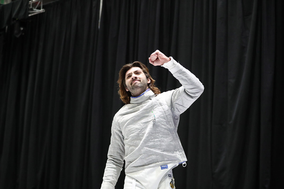 Luke Linder pumps his fist to celebrate a fencing national championship