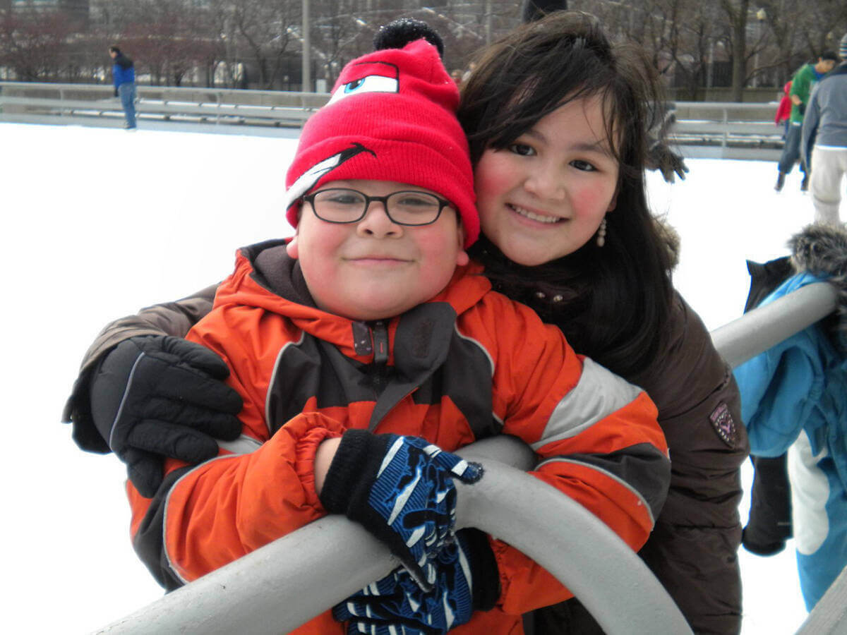 Two people pose for a photo while on a Horizons for Youth ice skating outing