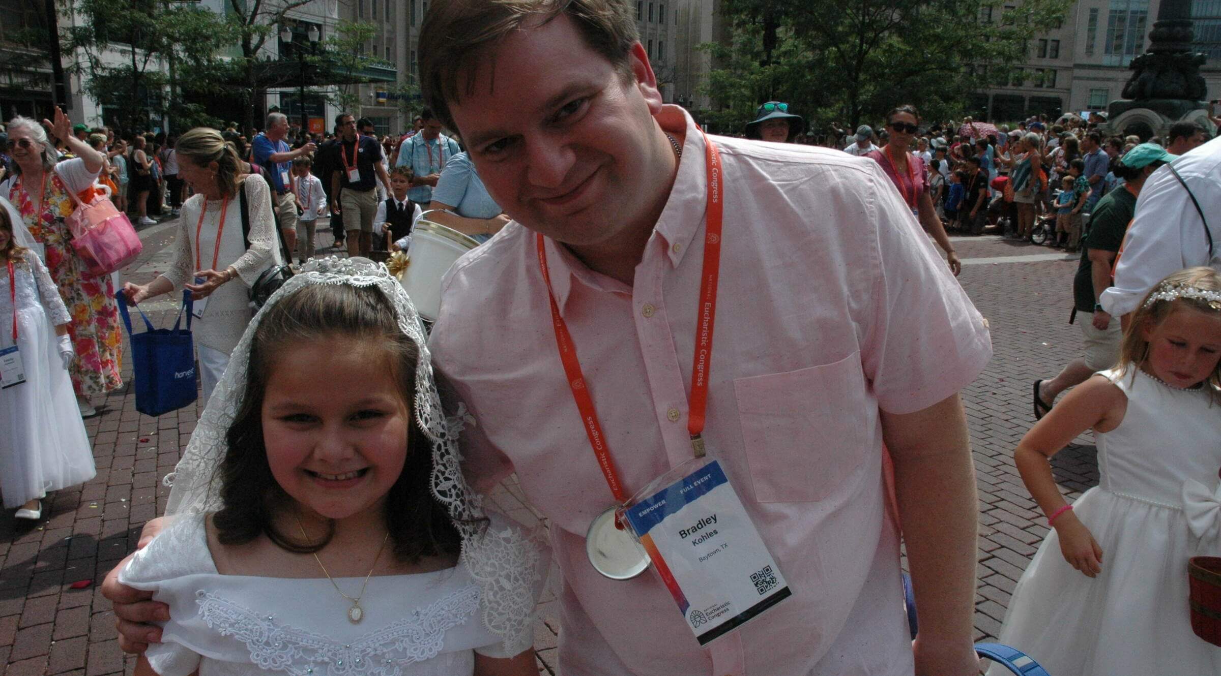 Eight-year-old Clarise Kohles, who received her first Communion earlier this year, poses for a photo with her dad, Bradley Kohles, as they participated with more than 50,000 Catholics in the eucharistic procession of the National Eucharistic Congress in Indianapolis on July 20.