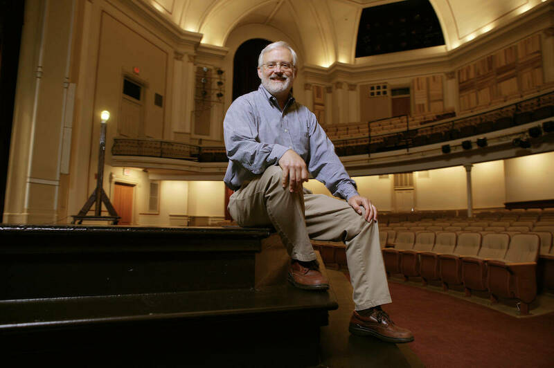 Mark Pilkinton sits on the steps leading to the stage at Washington Hall