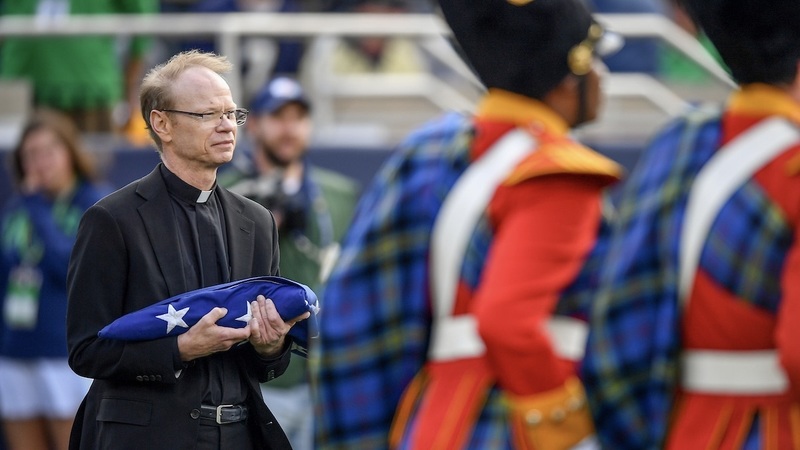 University of Notre Dame President Robert A. Dowd, C.S.C. presents the flag at the first home football game of the 2024 season.