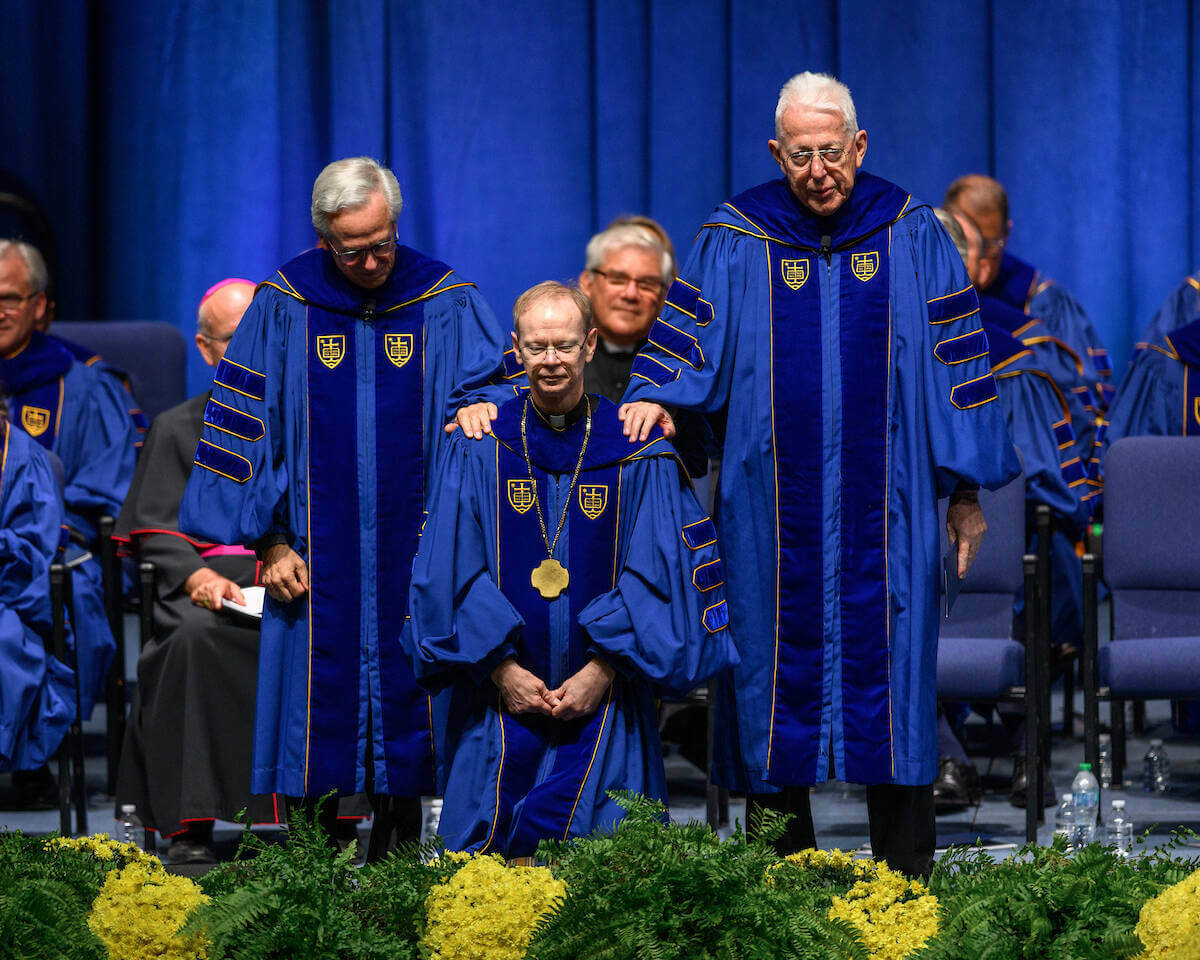 New University president Rev. Robert A. Dowd receives a blessing from his immediate predecessors Rev. John I. Jenkins and Rev. Edward A. Malloy