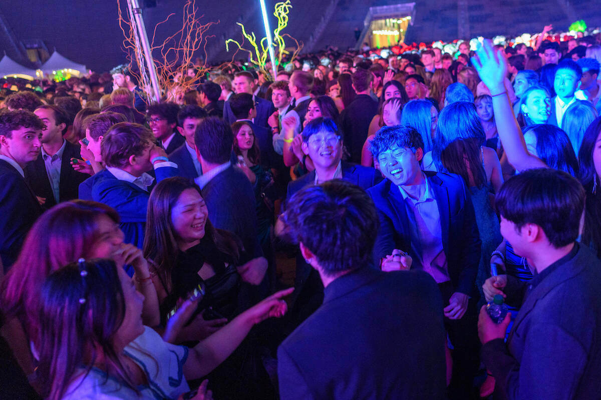 With colored lights shining, students dance during the inaugural ball honoring the new University president in Notre Dame Stadium