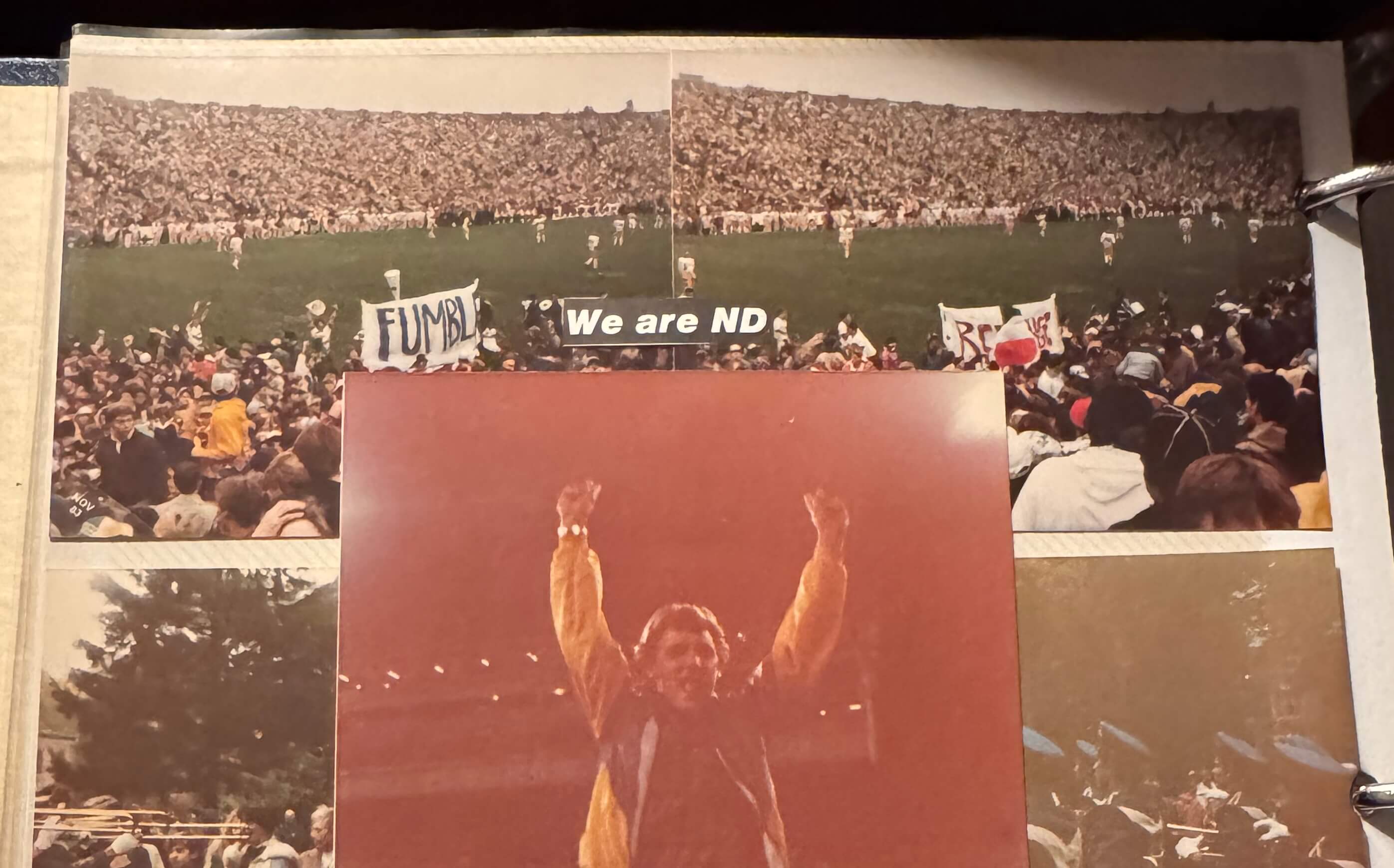 Jubilant man in gold jacket raises arms in victory, above photos of a crowded Notre Dame Stadium with "FUMBL" banners.